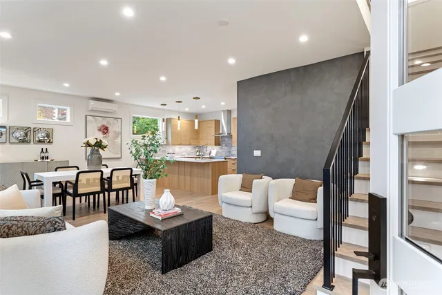 a living room with furniture and a dining table with kitchen view