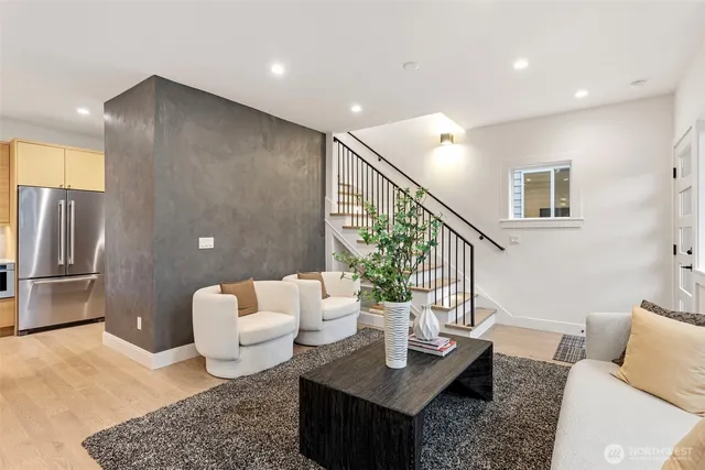 a living room with furniture and a potted plant