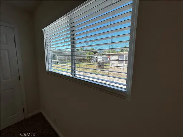 a view of an empty room and closet area