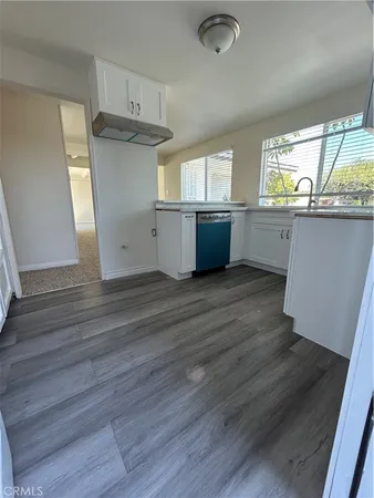 a view of kitchen with wooden floor and electronic appliances