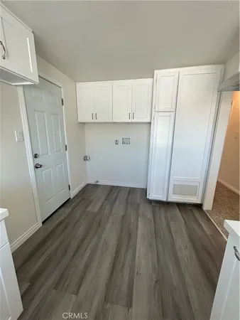 a view of a kitchen with wooden floor