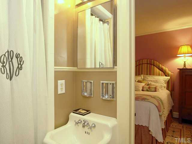 911 Runnymede Road Raleigh, NC 27607 - Photo 17 of 25 a bedroom with a bed and a window