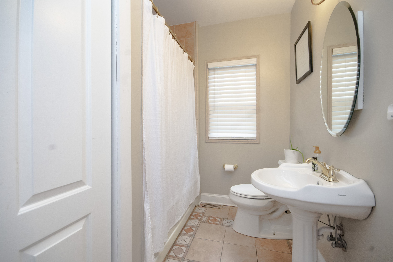 2614 Euclid Avenue Berwyn, IL 60402 - Photo 12 of 30 a bathroom with a sink a toilet and a mirror