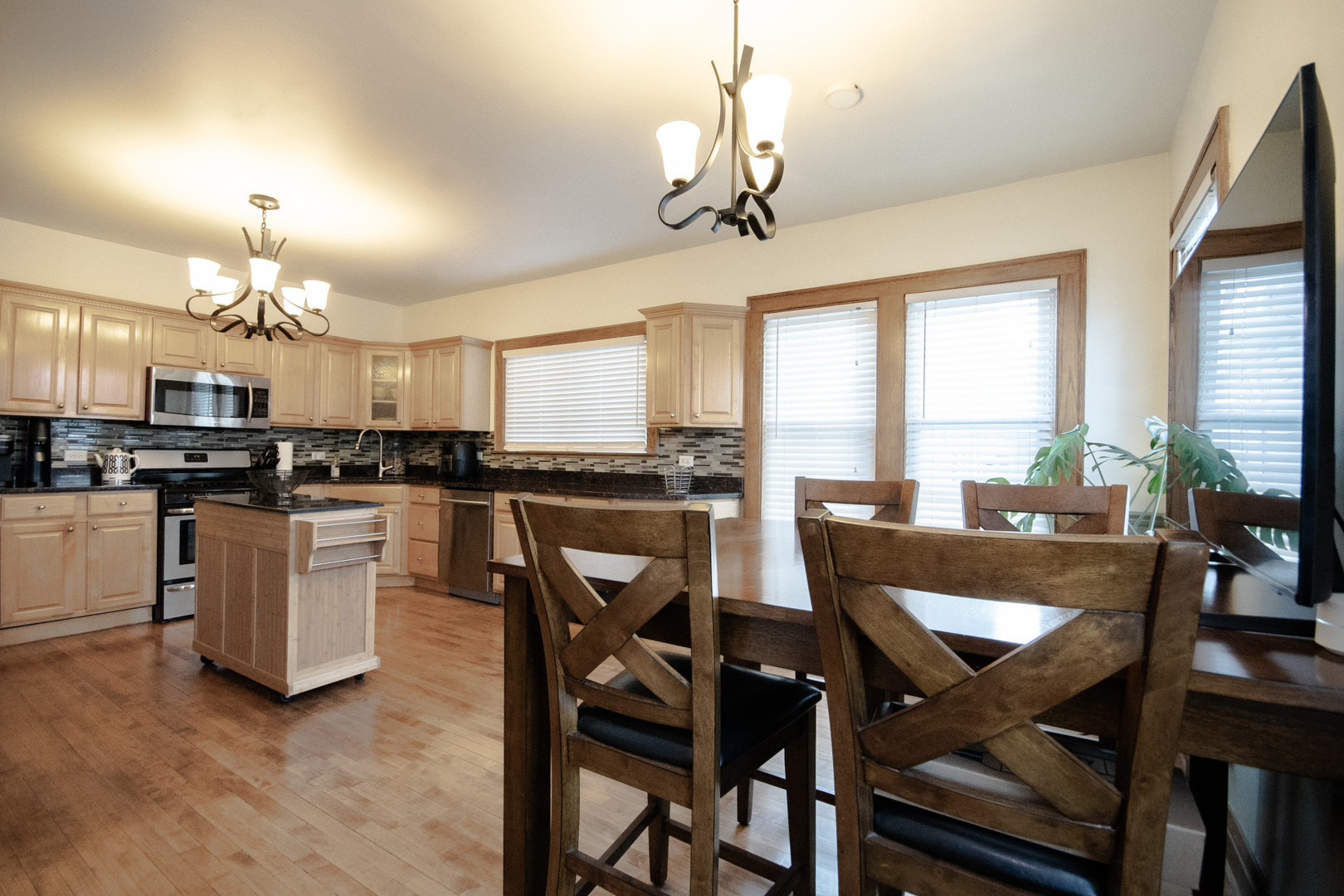 2614 Euclid Avenue Berwyn, IL 60402 - Photo 9 of 30 a view of a dining room with furniture a chandelier and large windows