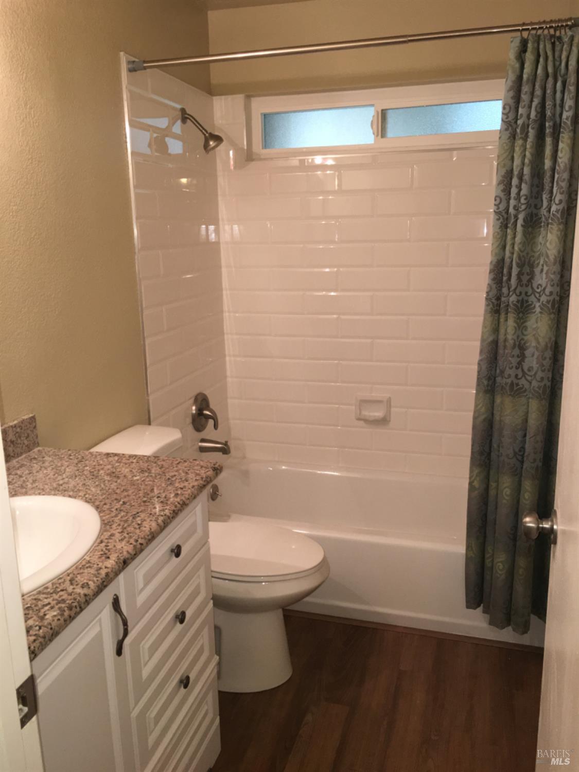 7643 Camino Colegio Rohnert Park, CA 94928 - Photo 4 of 10 a bathroom with a granite countertop sink toilet and shower