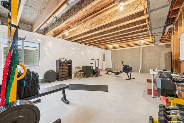 a view of a house with wooden deck and furniture