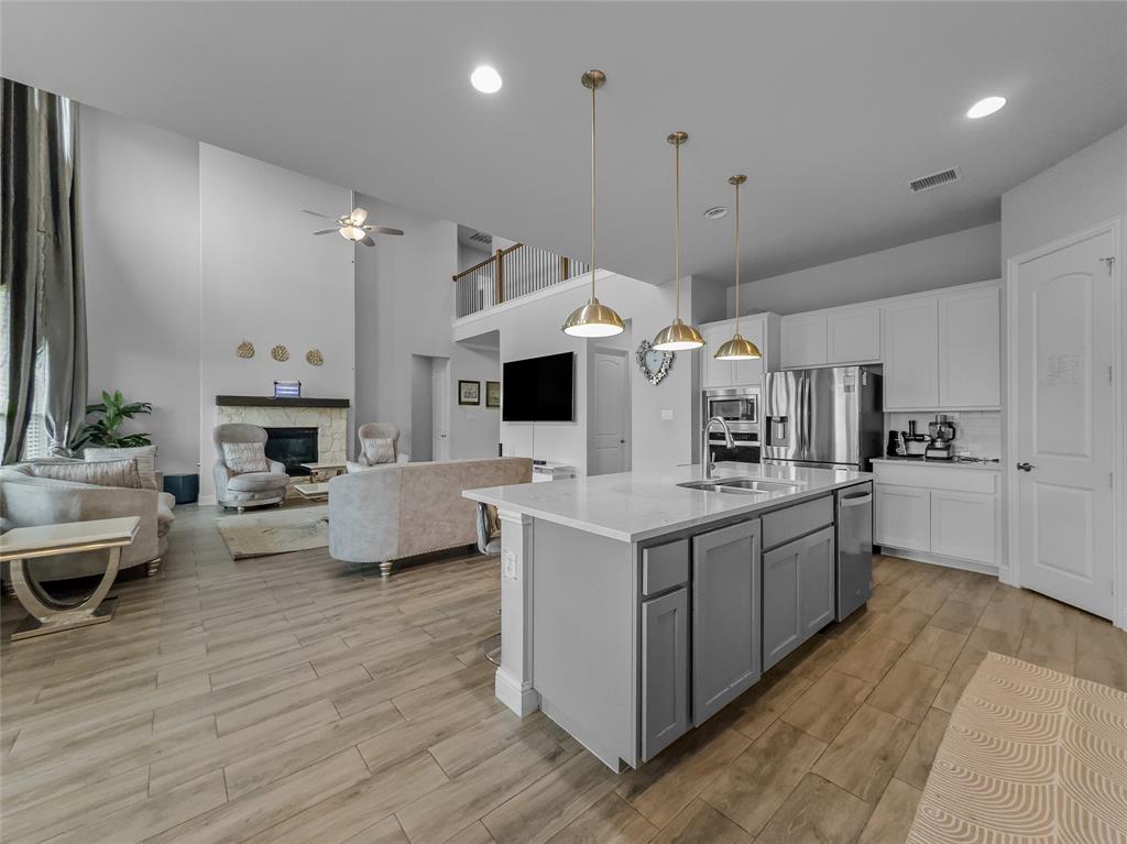 116 Chaco Drive Forney, TX 75126 - Photo 5 of 27 a kitchen with stainless steel appliances kitchen island granite countertop a stove and a refrigerator