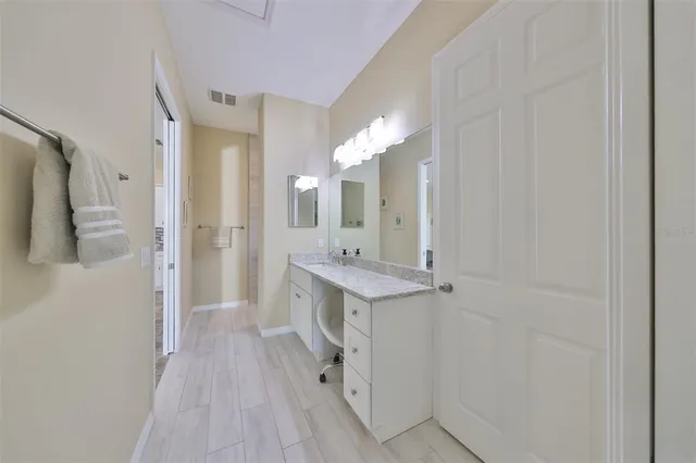 a bathroom with a sink a mirror and a shower