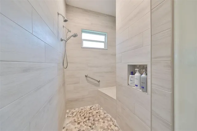 a bathroom with a bathtub and shower