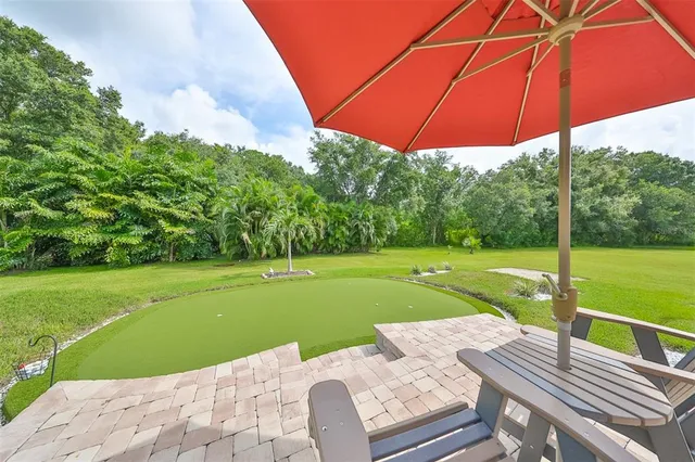 a view of a patio with a table chairs under an umbrella