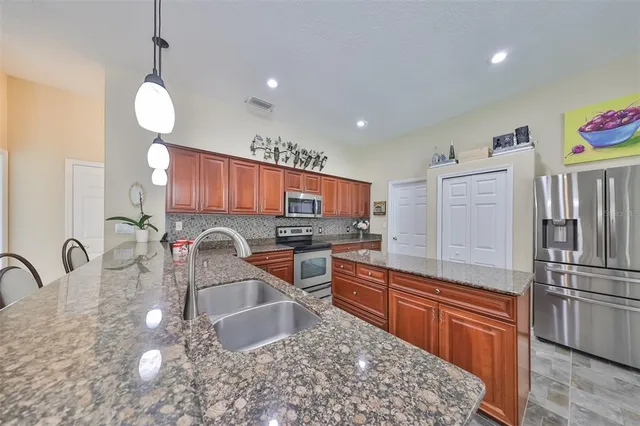 a kitchen with counter top space cabinets and stainless steel appliances