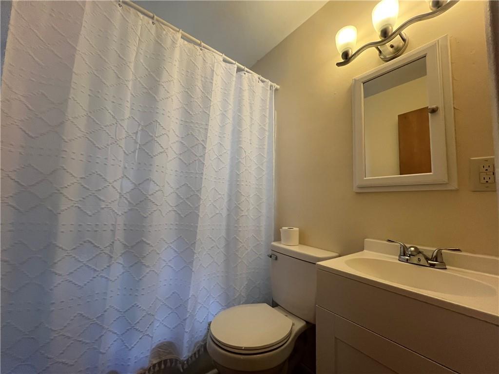2722 Old Plank Road New Castle, PA 16105 - Photo 12 of 12 a bathroom with a sink a toilet and shower curtain