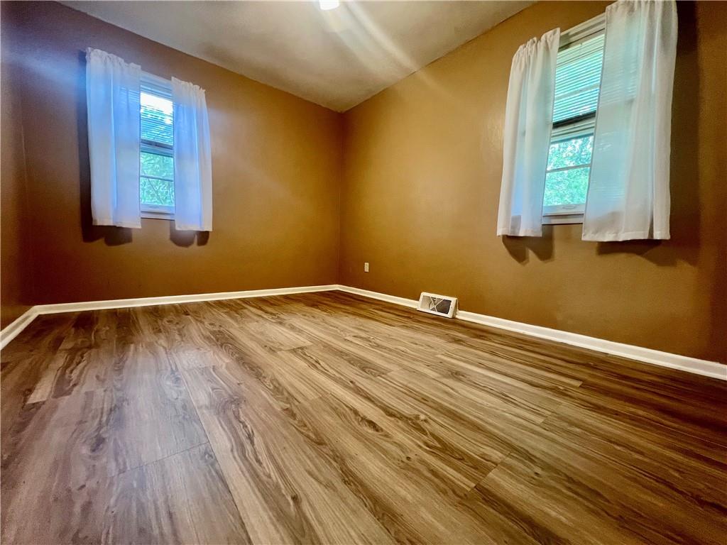 2722 Old Plank Road New Castle, PA 16105 - Photo 8 of 12 a room with a wooden floor and windows
