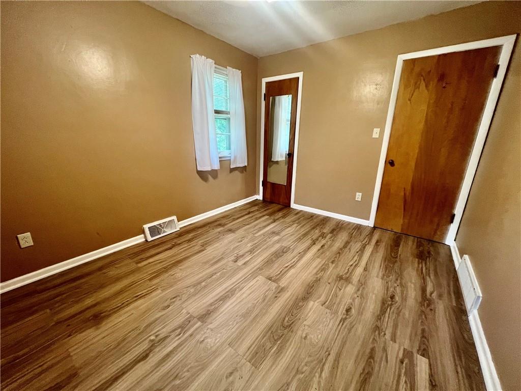 2722 Old Plank Road New Castle, PA 16105 - Photo 9 of 12 an empty room with wooden floor and entrance