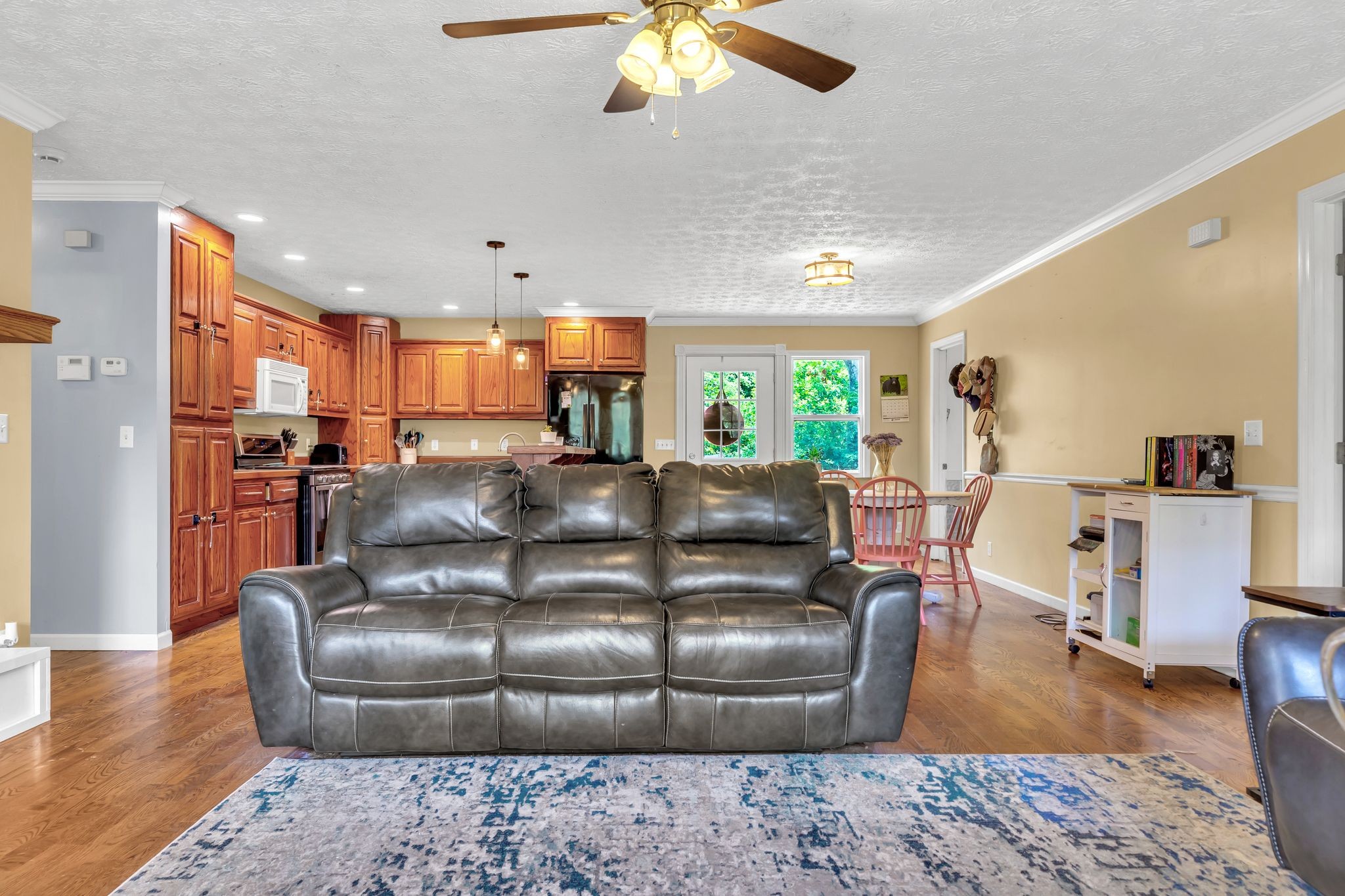 1450 Pleasant Hill Road McMinnville, TN 37110 - Photo 8 of 33 a living room with a couch and a dining table with wooden floor