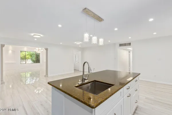 a kitchen with a sink and a refrigerator