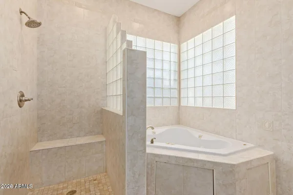 a bathroom with a bathtub and shower