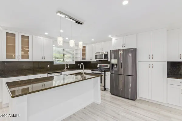 a kitchen with refrigerator and cabinets