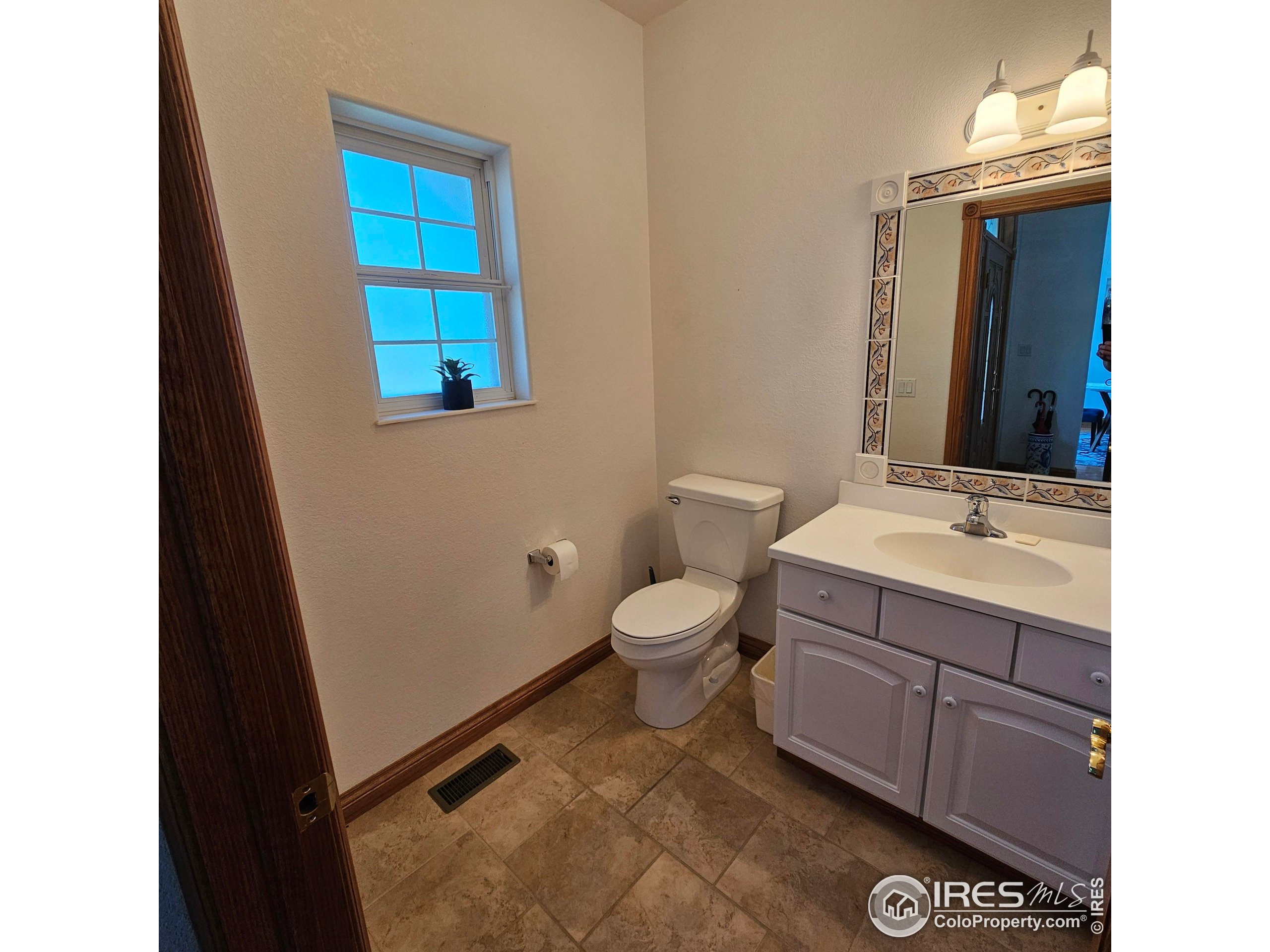 17606 County Rd Q.8 Fort Morgan, CO 80701 - Photo 23 of 37 a bathroom with a sink a toilet and mirror