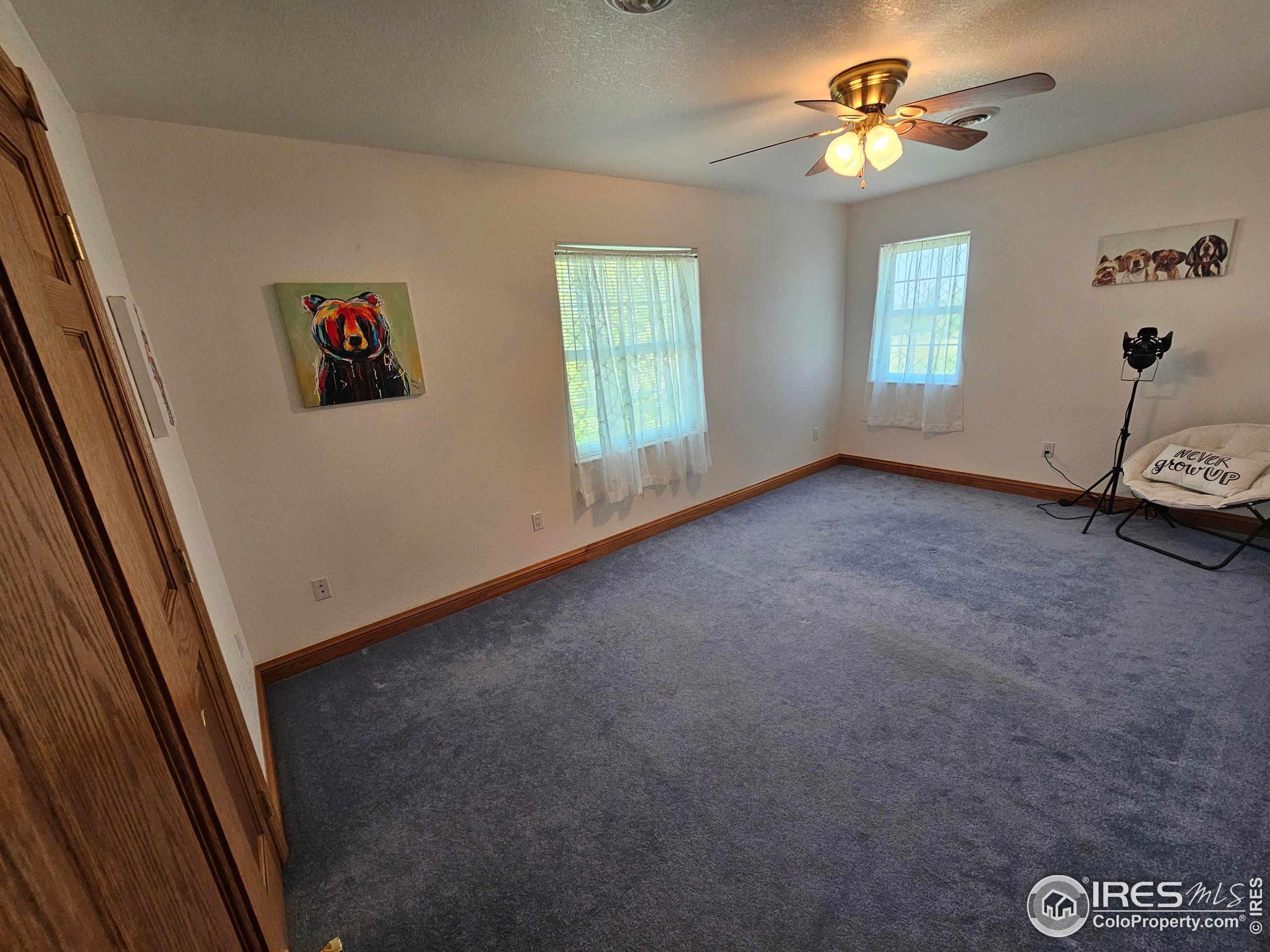 17606 County Rd Q.8 Fort Morgan, CO 80701 - Photo 26 of 37 an empty room with windows and ceiling fan