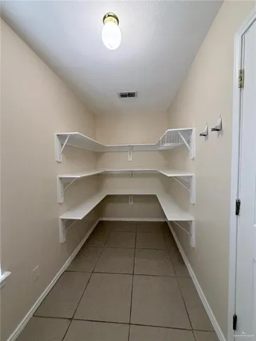 a large kitchen with granite countertop a sink and cabinets