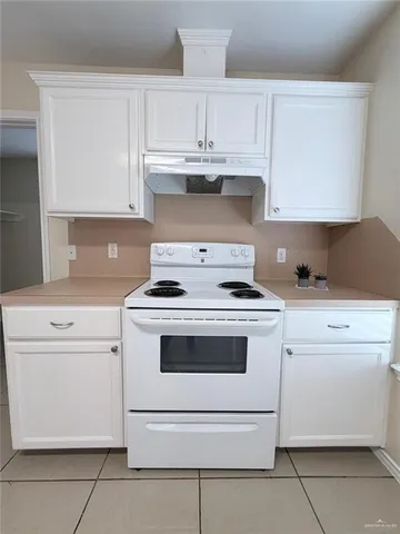 a stove top oven sitting inside of a kitchen