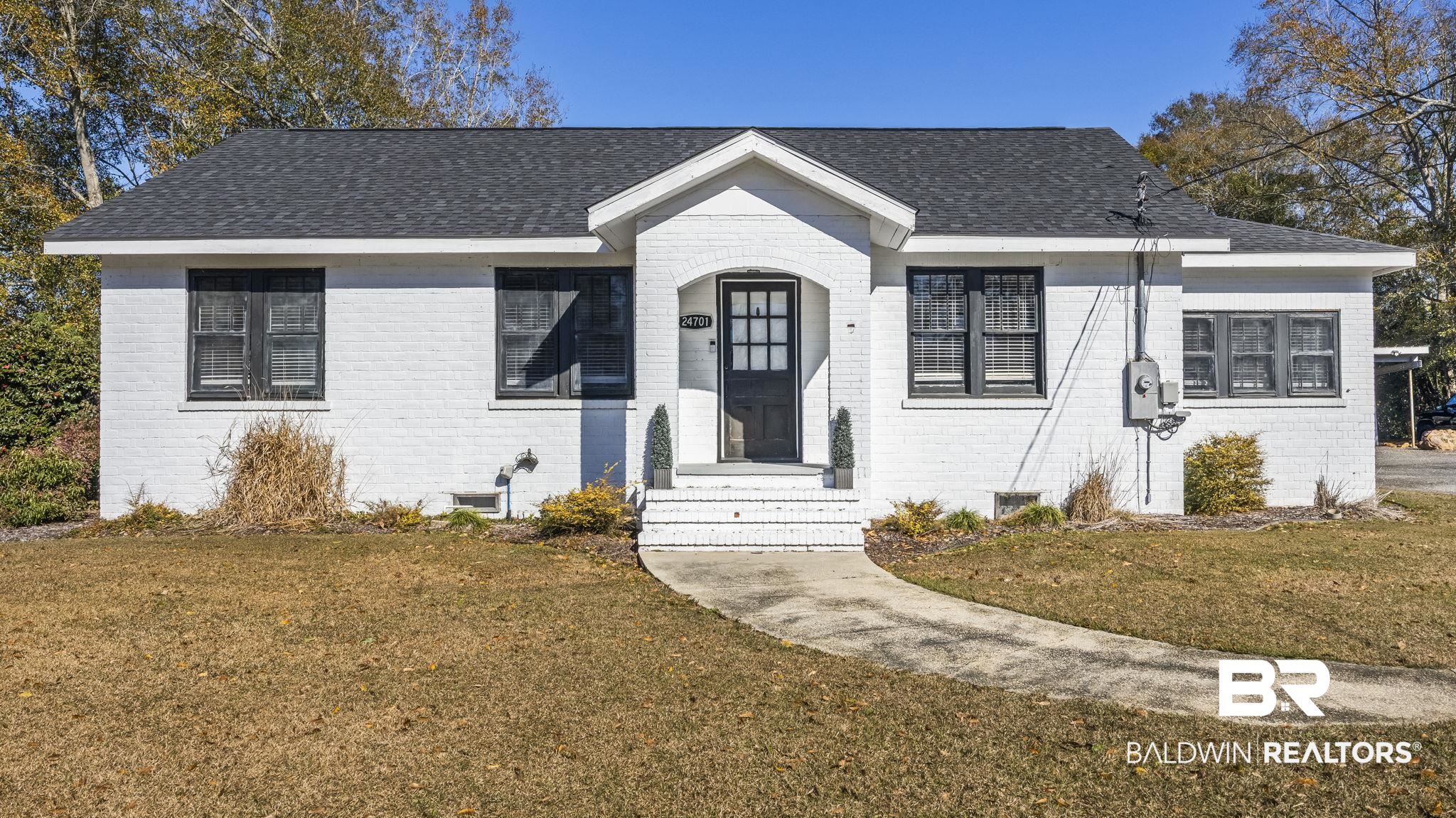24701 Highway 98 Elberta, AL 36530 - Photo 1 of 32 View of front facade featuring brick siding, a front yard, and a shingled roof