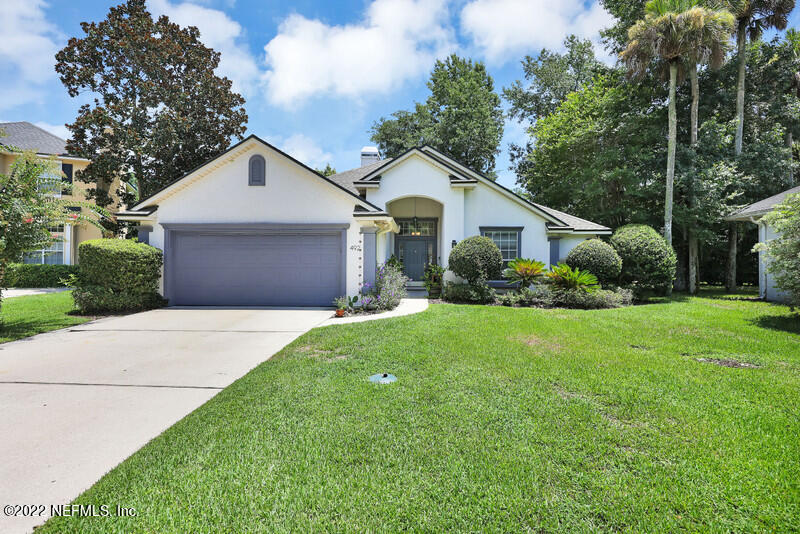 492 Big Tree Road Ponte Vedra Beach, FL 32082 - Photo 1 of 32 a view of a yard in front of a house with plants and large tree