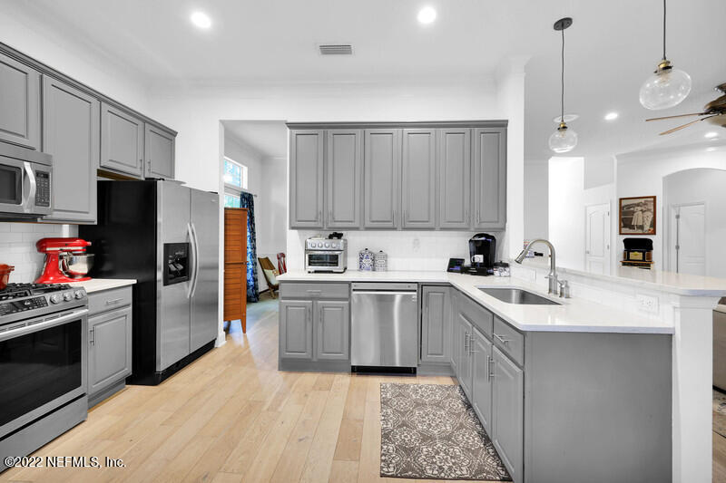 492 Big Tree Road Ponte Vedra Beach, FL 32082 - Photo 14 of 32 a kitchen with a sink stainless steel appliances and cabinets