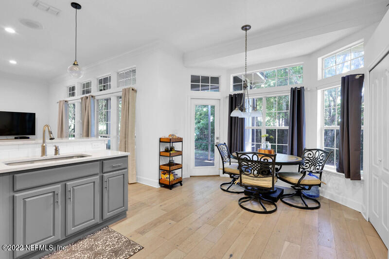492 Big Tree Road Ponte Vedra Beach, FL 32082 - Photo 15 of 32 a view of a dining room and livingroom with furniture wooden floor a chandelier