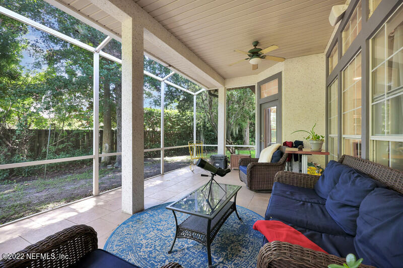 492 Big Tree Road Ponte Vedra Beach, FL 32082 - Photo 26 of 32 a living room with furniture and a floor to ceiling window