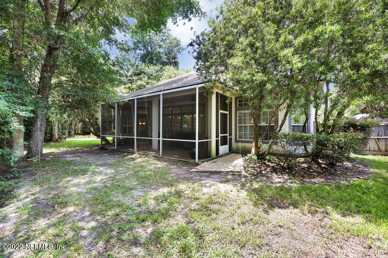 492 Big Tree Road Ponte Vedra Beach, FL 32082 - Photo 27 of 32 a view of a backyard with floor to ceiling window and tree
