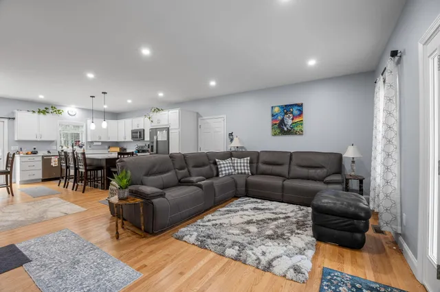 a living room with furniture and kitchen view