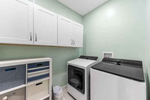a utility room with sink dryer and washer