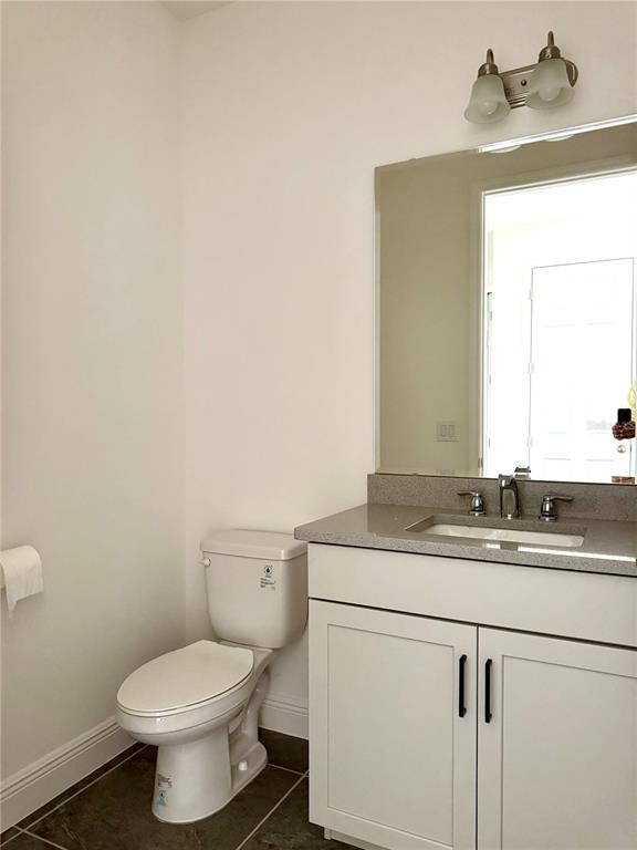 394 Switchgrass Loop Minneola, FL 34715 - Photo 15 of 26 a bathroom with a granite countertop toilet sink and mirror