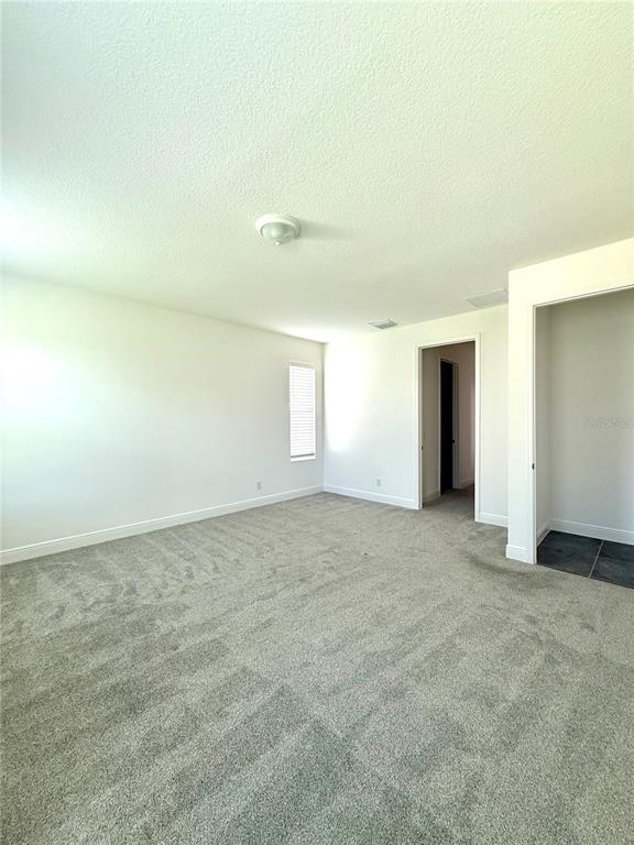 394 Switchgrass Loop Minneola, FL 34715 - Photo 19 of 26 a view of an empty room with a window