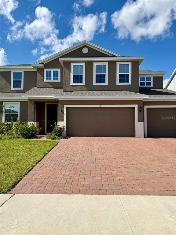 394 Switchgrass Loop Minneola, FL 34715 - Photo 2 of 26 a front view of a house with a yard