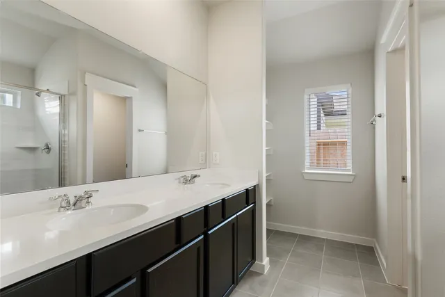 a bathroom with a double vanity sink a mirror and a