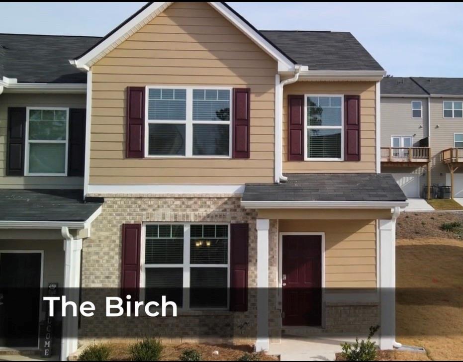 6113 Rockaway Road Atlanta, GA 30349 - Photo 1 of 1 a front view of a house with a parking area