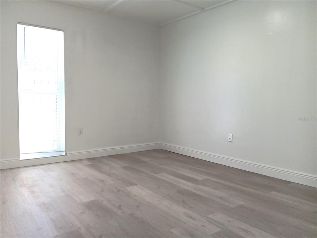 885 Beltrees Street, Unit 15 Dunedin, FL 34698 - Photo 7 of 12 an empty room with a window