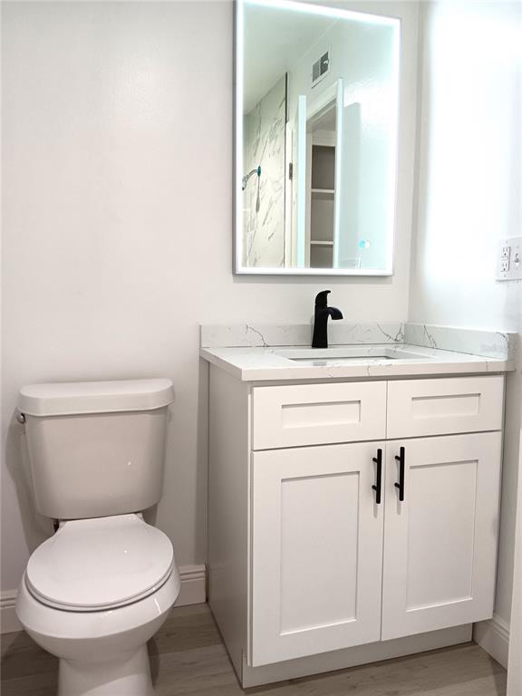 885 Beltrees Street, Unit 15 Dunedin, FL 34698 - Photo 10 of 12 a bathroom with a toilet sink and mirror