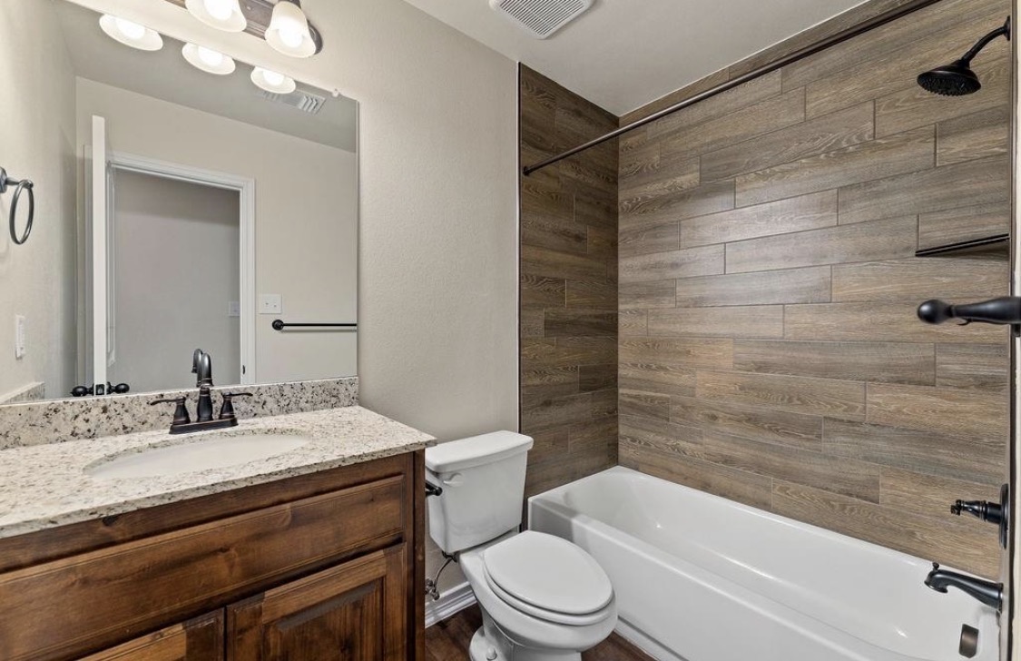 113 Calvin Smith Ln. Lane Jarrell, TX 76537 - Photo 12 of 16 a bathroom with a sink a toilet and shower