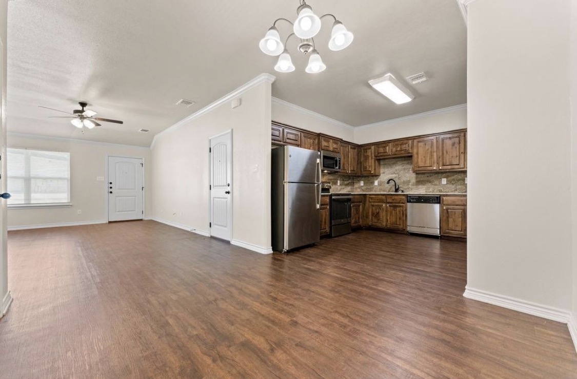 113 Calvin Smith Ln. Lane Jarrell, TX 76537 - Photo 16 of 16 a view of a kitchen with a sink a refrigerator and a chandelier