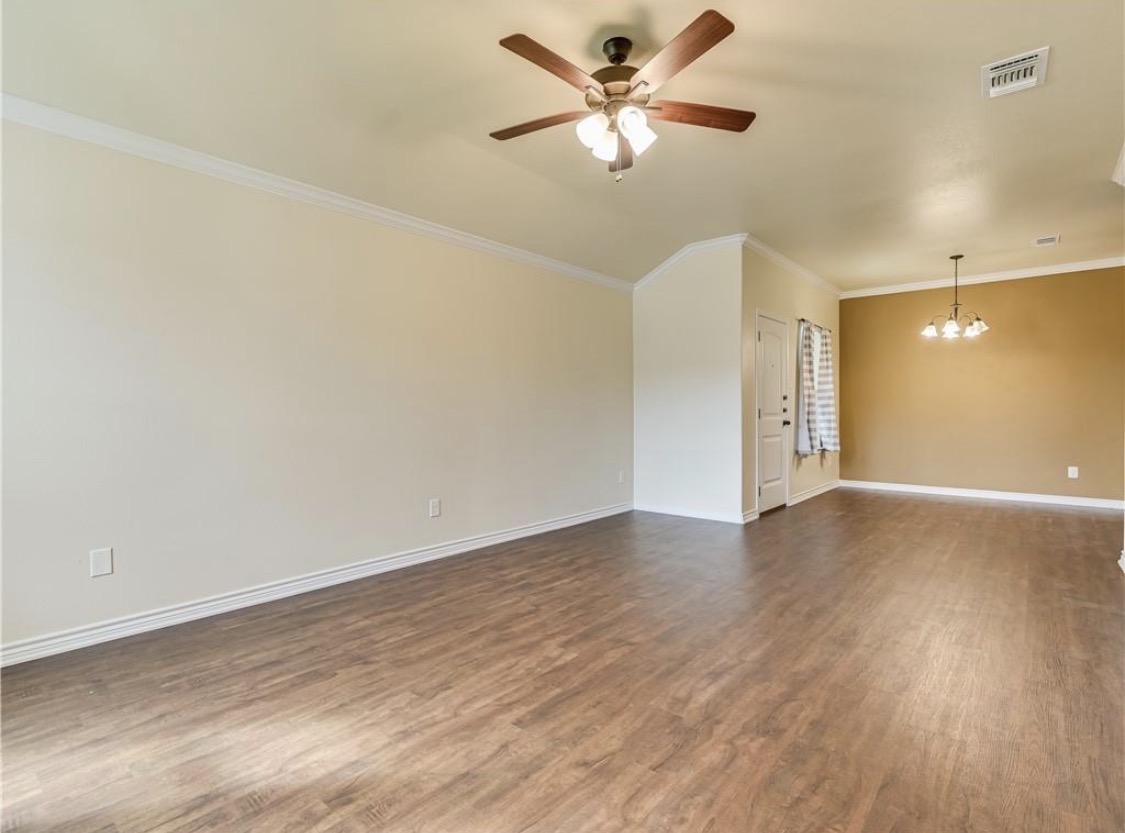 113 Calvin Smith Ln. Lane Jarrell, TX 76537 - Photo 7 of 16 an empty room with wooden floor and a ceiling fan