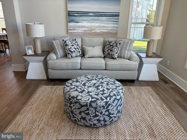 a living room with furniture and a lamp