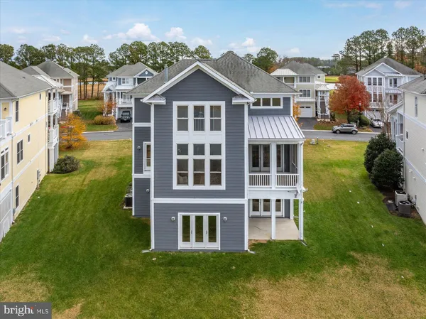 a view of a big yard in front of a brick house