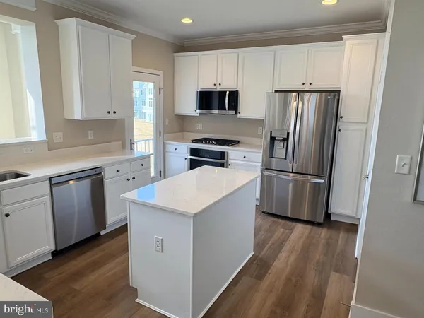 a kitchen with a refrigerator sink and microwave