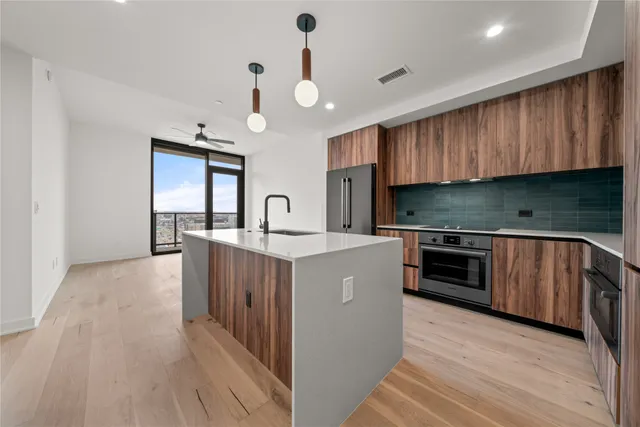 a kitchen with granite countertop wooden cabinets and white appliances