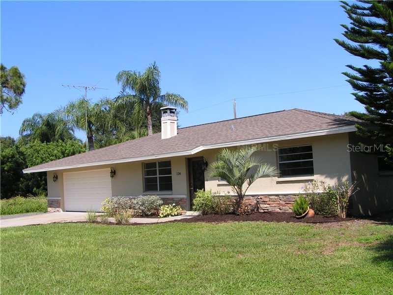 124 Temple Road Venice, FL 34293 - Photo 1 of 1 a front view of a house with a garden and yard