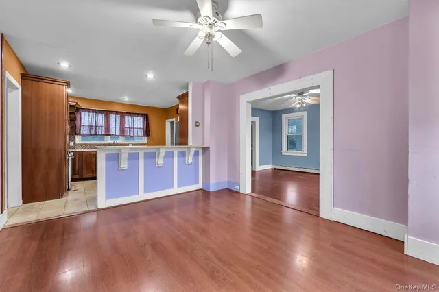 a view of a kitchen with a stove wooden floor and a kitchen